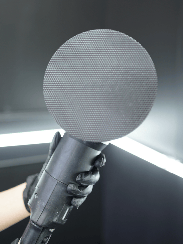 A clay buffing pad on a buffing machine