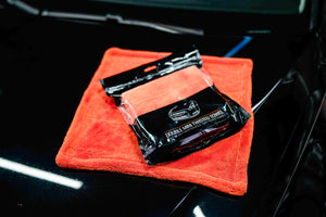 ADBL Double Mini Twisted Towel package resting on black car hood
