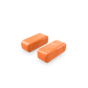 Two orange soft clay bars on a white background