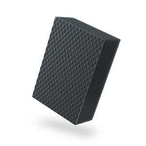 A black textured clay sponge on a white background