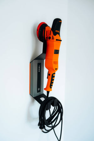 ADBL HANG IT HIGH metal wall bracket holding orange polishing machine securely