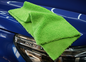 A green microfibre cloth on a blue car