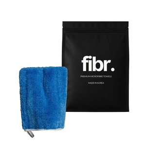 A black bag with FIBR written on it next to a blue interior scrub mitt