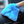 A person holding a blue car interior scrub mitt cleaning a dashboard