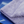 Folded purple microfibre cloth on a blue car