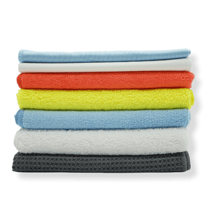 A stack of various microfibre cloths stacked on a white background