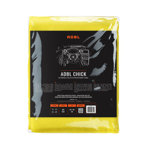 A yellow microfibre cloth in packaging on a white background 