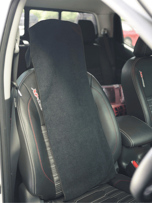 Black car seat cover on a vehicle seat with visible branding.