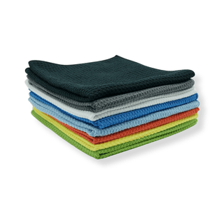 A stack of colourful waffle microfibre cloths on a white background